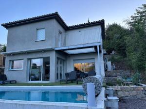 a house with a swimming pool in front of it at Villa Catamaran in Aubenas