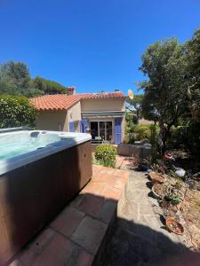 a house with a hot tub in a yard at Villa Les Chênes - Golf de Saint-Tropez Experience in Port Grimaud
