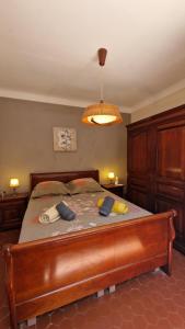 a bedroom with a large bed with a wooden frame at Villa Les Chênes - Golfe de Saint-Tropez Experience in Port Grimaud