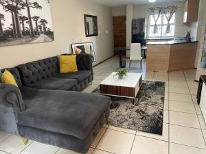 a living room with a couch and a table at The Northern Star in Sandton