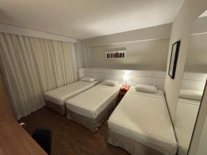 Cama ou camas em um quarto em Intercity BH Expo