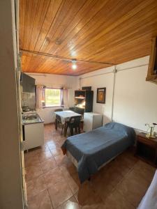 a bedroom with a bed and a table in it at Casa de chacra in Veinticinco de Mayo