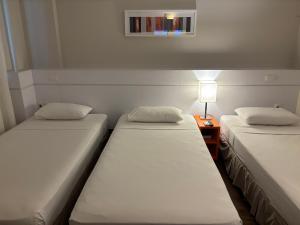 Cama ou camas em um quarto em Intercity BH Expo