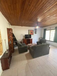 a living room with couches and a wooden ceiling at Casa de chacra in Veinticinco de Mayo +11 photos