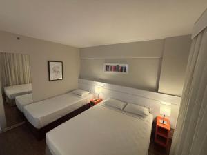 Cama ou camas em um quarto em Intercity BH Expo