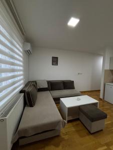 a living room with a couch and a table at Apartman Pale - Biljana in Pale