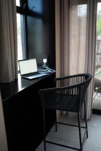 a laptop computer sitting on a desk with a chair at Casa TzinTzun in Temalhuacán