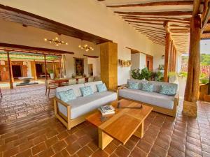 a living room with two couches and a coffee table at Santa Sofia Casa Boutique in Barichara