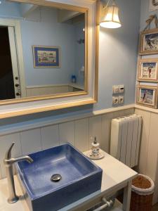 a bathroom with a blue sink and a mirror at La Casa Del Pla in Pla de l'Ermita +32 photos