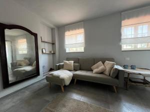 a living room with a couch and a mirror at La Ghiandaia in Mortara