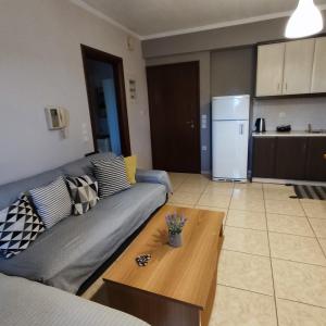 a living room with a couch and a coffee table at Aquarium in Patra