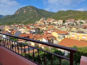 a view from a balcony of a town with mountains at Dimora mediterranea Fontanamare in Gonnesa