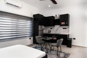 a kitchen with a table and chairs in a room at The Kottage Studio Apartment A in Accra