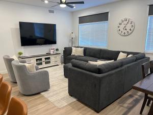 a living room with a couch and a flat screen tv at New Resort Condo Near Zion Great for Families Pools Water Slide in Hurricane