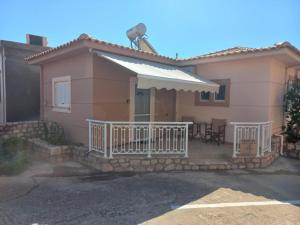 a small house with a porch and an awning at Sophie's Sunny Spot 4 in Yéfira