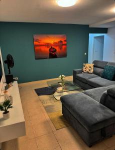 a living room with a couch and a table at Élégance in Baie-Mahault