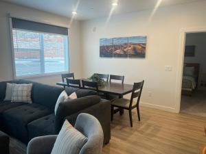 a living room with a couch and a table and chairs at New Resort Condo Near Zion Great for Families Pools Water Slide in Hurricane