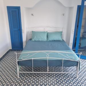 a bed in a room with a blue door at Private villa with pool in Bouznika +31 photos