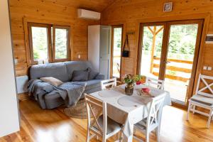 a living room with a couch and a table at Jak u Dziadka in Rak