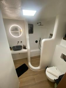 a bathroom with a sink and a toilet at Verde Studio Steni, Tinos in Stení +9 photos