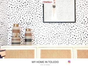 a wall with a picture and some bottles on a counter at -TÍVOLI- by myhomeintoledo in Toledo