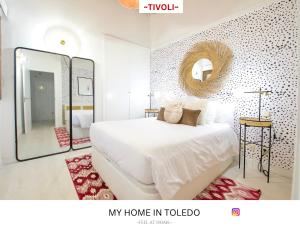 a bedroom with a white bed and a mirror at -TÍVOLI- by myhomeintoledo in Toledo +19 photos
