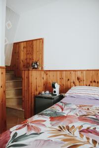 a bedroom with a bed with a flower blanket at Angolo Laggetto Rooms in Otranto