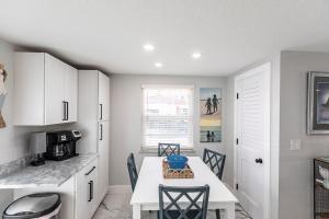 a kitchen and dining room with a table and chairs at Casa Blanca - VC16 in Siesta Key