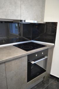 a kitchen with a black stove top oven at kaleos in Nea Chili