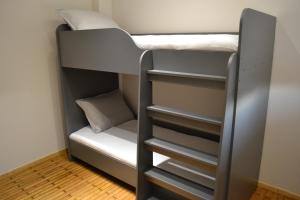 a bunk bed in a small room with a pillow at kaleos in Néa Khilí +26 photos