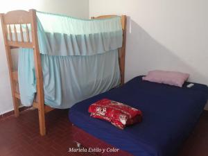 a bed in a room with a bunk bed at Quintana in Asunción +3 photos