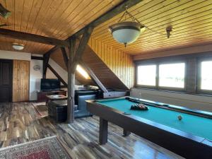 a pool table in a room with wooden ceilings at Lovačka kuća Draganić in Draganići