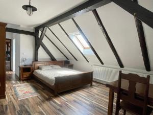 a bedroom with a bed in the attic at Lovačka kuća Draganić in Draganići
