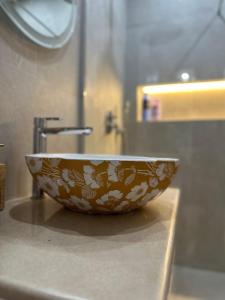 a bowl sitting on top of a sink in a bathroom at Casa Eira's Dhermi in Gjilek +21 photos