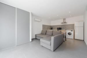 a living room with a couch and a kitchen at Ciotat t2 in La Ciotat +3 photos