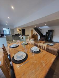 a wooden table with plates on it in a living room at Coach House Innellan in Innellan