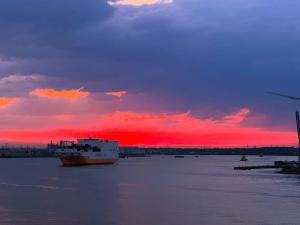 a large boat in the water with a sunset at Serenity Waterfront 2 Bed Apartment in Northfleet