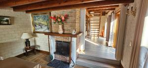 a living room with a brick fireplace in a house at Hof van Lapscheure in Damme +16 photos