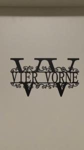 a sign on a wall that reads vier vienne at Über den Dächern im Vier Vorne in Gütersloh