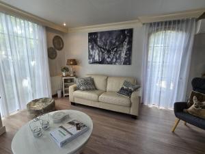 een woonkamer met een bank en een tafel bij Urbane Holiday Home in Garderen with Terrace and Garden in Garderen
