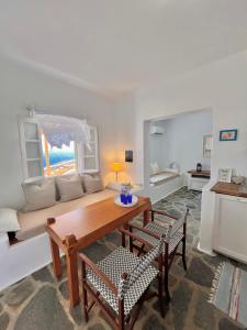 a living room with a table and a couch at Akra in Houlakia