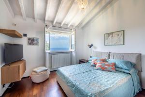 a bedroom with a bed and a television at Portofino Riviera Luxury Villa-Pool,Garden,Parking in Zoagli