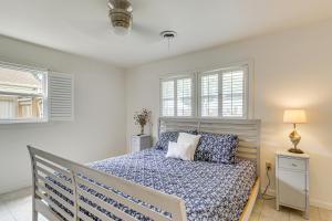 a bedroom with a bed and two windows at Riverfront Fun Quiet Home Near Hampton Coastline in Hampton