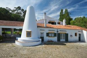 a house with a large white tower in front of it at Very Quiet Place in Sintra