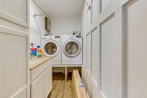 a laundry room with a washer and dryer at Riverfront Fun Quiet Home Near Hampton Coastline in Hampton