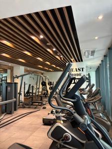 a gym with several tread machines in a row at Luxury at Solaris Appartment in Accra
