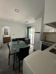 a kitchen and living room with a table and chairs at Alex Guest House in Quinta do Anjo +15 photos