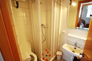 a bathroom with a shower and a toilet and a sink at La Brisa - ocean view holiday apartment in Calpe in Calpe +12 photos
