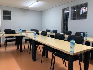 a room with tables and chairs with water bottles on them at Glowti Event & Guest House in Centurion +5 photos