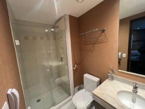 a bathroom with a shower and a toilet and a sink at Hotel Wydn Ibirapuera Moema in Sao Paulo